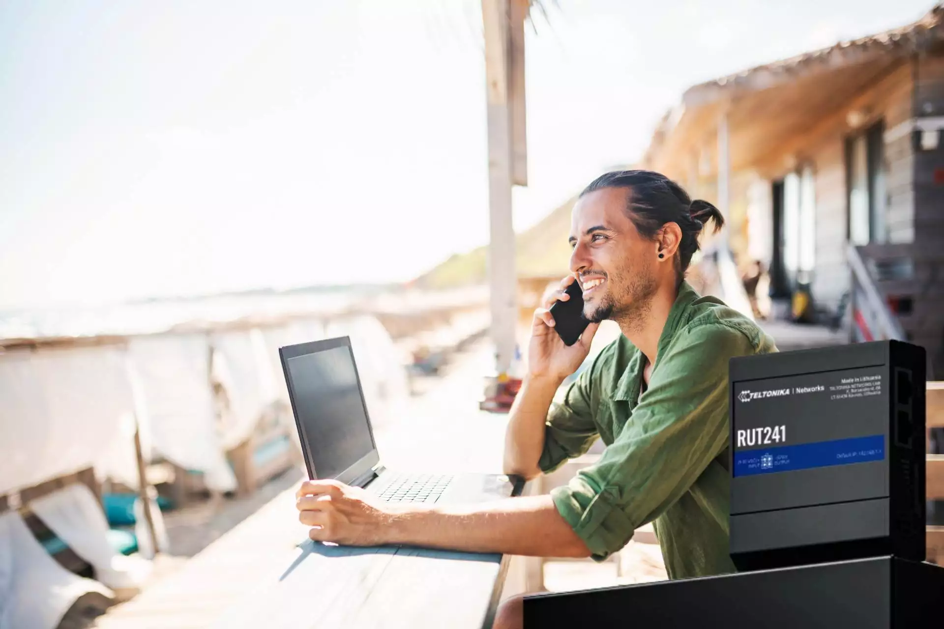 Remote worker using eSIM router at beach